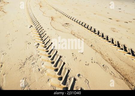 Wheel tracks of the tractor on a tropical sandy beach with a sunny Stock Photo