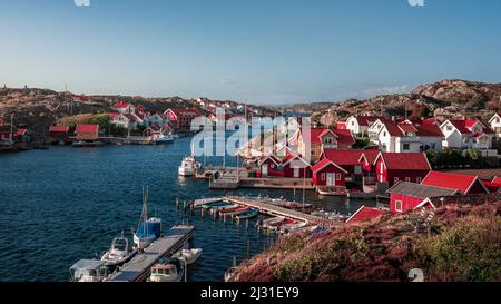 Harbor and coast in the village of Kyrkesund on the archipelago island of Tjörn on the west coast of Sweden, blue sky with sun Stock Photo