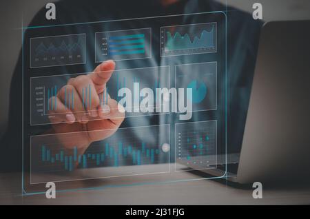 man hand using laptop to working technology.Hand toucing virtual screen graph and chart data analysis and big data business concept. Stock Photo