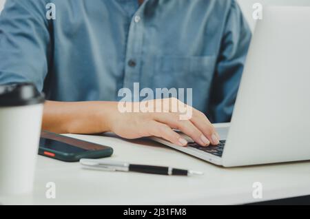 Business man using laptop computer at home. Stock Photo
