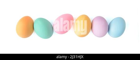 Pastel coloured Easter eggs in a line row isolated on white background, top view Stock Photo