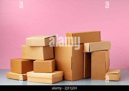 Set of cardboard boxes on pink background Stock Photo