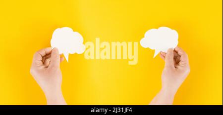 Holding a white cloud in the hand, empty copy space for text, yellow background, communication and marketing concept, being connected, networking Stock Photo