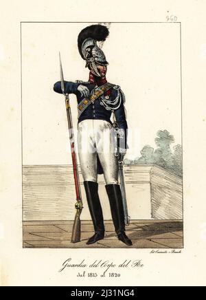 Uniform of the French Life Guards, Bourbon Restoration, 1815-1820. In dragoon's helmet with brush, blue coat with red collar, breeches, boots, armed with musket and sword. Garde du Corps du Roi de 1815 a 1820. Handcoloured lithograph by Lorenzo Bianchi and Domenico Cuciniello after Hippolyte Lecomte from Costumi civili e militari della monarchia francese dal 1200 al 1820, Naples, 1825. Italian edition of Lecomte’s Civilian and military costumes of the French monarchy from 1200 to 1820. Stock Photo