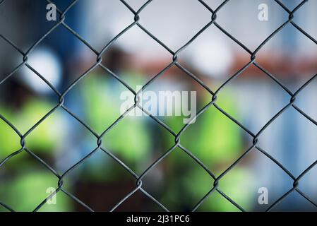 Keep your site secure at all costs. Shot of a group of unrecognisable builders inspecting a construction site behind a fence. Stock Photo