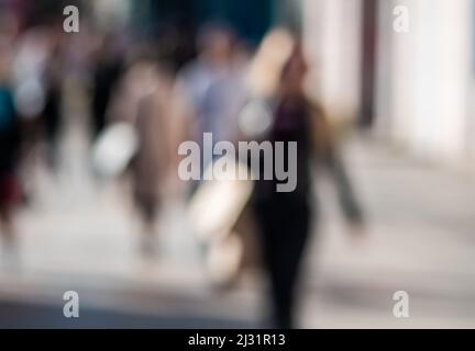 Out of focus background with people crossing street. Stock Photo