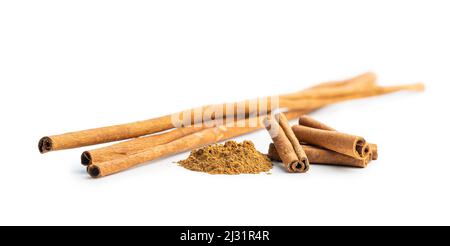 Dry cinnamon sticks and cinnamon powder isolated on a white background. Cinnamon spice. Stock Photo