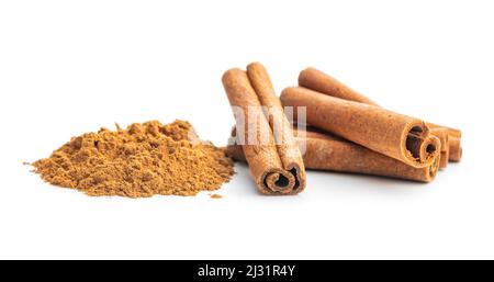 Dry cinnamon sticks and cinnamon powder isolated on a white background. Cinnamon spice. Stock Photo