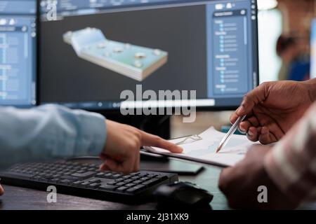 Close up of creative industry employees with clipboard and advanced 3D modeling software open in background. 3D digital artists reviewing sketch scene plan and simulated render times, Stock Photo