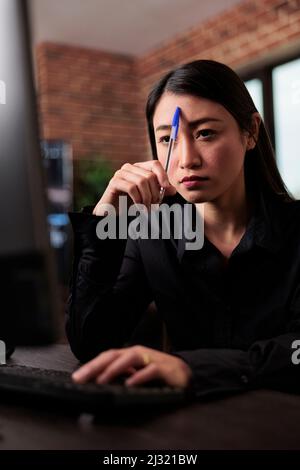 Thoughtful blockchain developer reflecting at low levels of security and how to improve mainframe defence system. Pensive network engineer thinking of failed data processing operation. Stock Photo