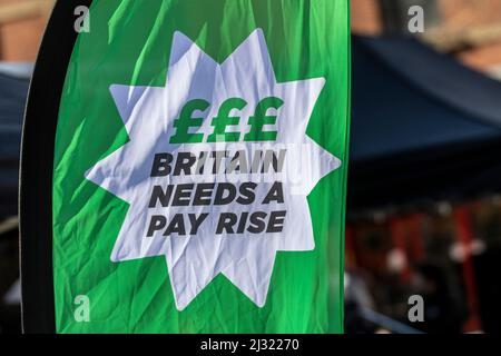 Green Feather Banner 'Britain needs a pay rise' in Preston, UK Stock Photo