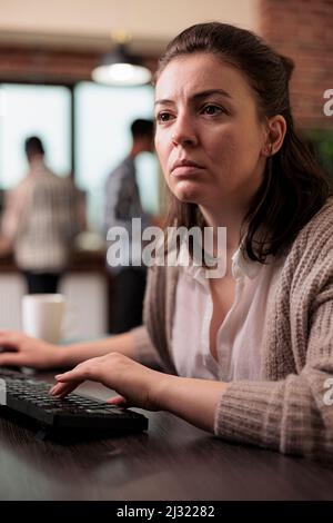 Confident cyber security officer accesing administrator rights by bypassing firewall defence system. Cybernetics engineer writing lines of code in order to secure mainframe database storage. Stock Photo