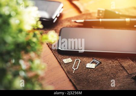 SIM card for smart phone. Changing the SIM card. Stock Photo