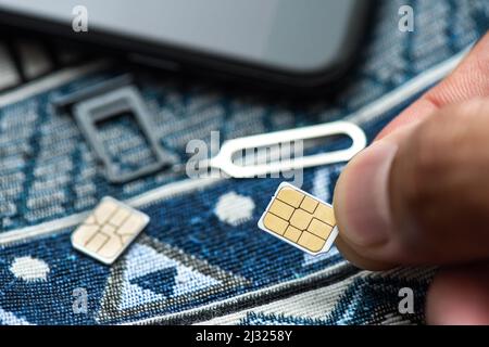 SIM card for smart phone. Changing the SIM card. Stock Photo