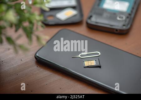 SIM card for smart phone. Changing the SIM card. Stock Photo