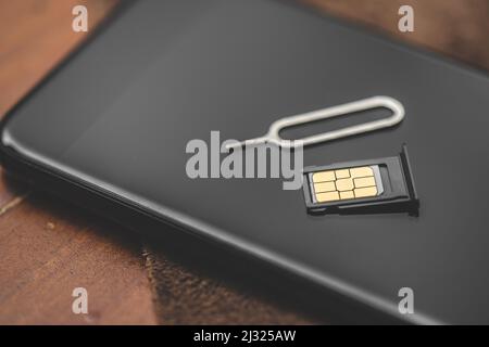 SIM card for smart phone. Changing the SIM card. Stock Photo