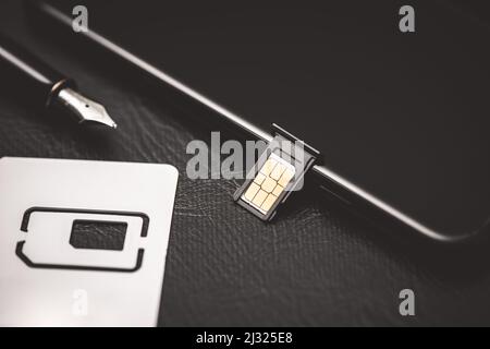 SIM card for smart phone. Changing the SIM card. Stock Photo