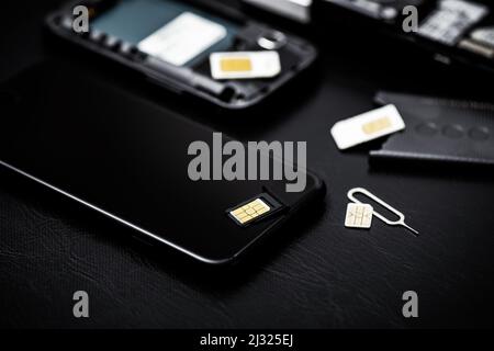 SIM card for smart phone. Changing the SIM card. Stock Photo