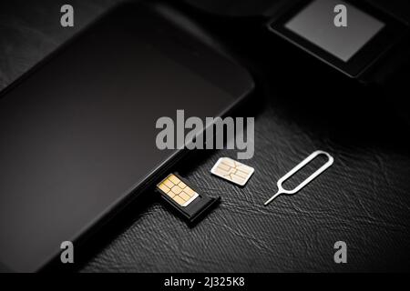 SIM card for smart phone. Changing the SIM card. Stock Photo