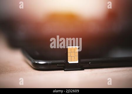 SIM card for smart phone. Changing the SIM card. Stock Photo