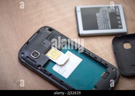 SIM card for smart phone. Changing the SIM card. Stock Photo