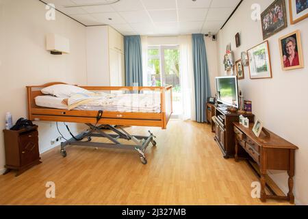 Netherlands, room in a nursing home for elderly with a high low bed. Stock Photo
