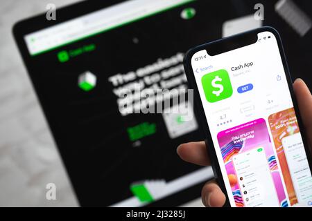 Poltava, Ukraine - April 5, 2022: Cash app icon. Hand with mobile phone with application. Mobile banking and investment concept Stock Photo