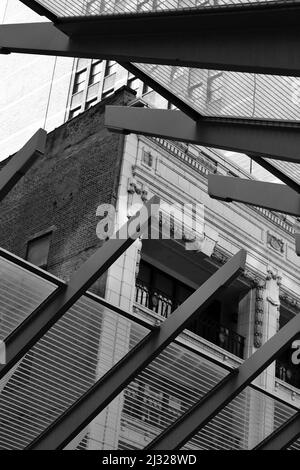 Decorative steel beams constructing the roof of the local downtown train platform in black and white. Stock Photo