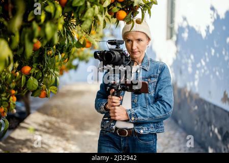 Camera operator with movie setup including a gimbal, video transmitter and wireless microphone Stock Photo