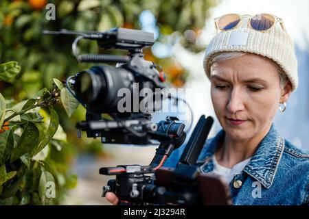 Camera operator with movie setup including a gimbal, video transmitter and wireless microphone Stock Photo