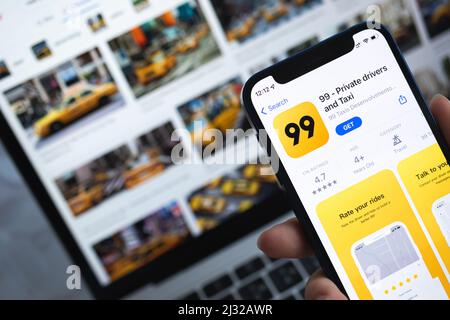 99 taxi app on smartphone screen. Application icon close-up view Stock Photo