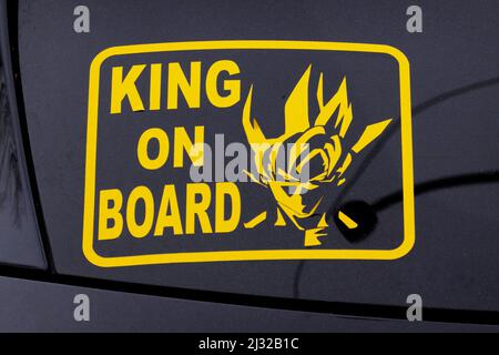 An unusual sticker on the back window of a car proclaiming the King is on board. In Queens, New York. Stock Photo