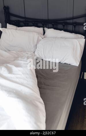 Soft pillows and duvet on comfortable bed Stock Photo
