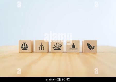 Renewable and green energy concept. Eco evolution for saving the world. Wooden cubes with clean energy sources; solar, wind, geothermal, water and bio Stock Photo