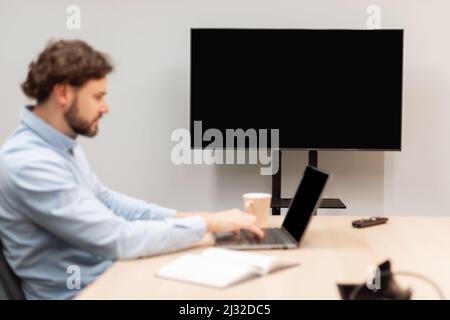 Worker Using Laptop, Focus On Monitor With Black Empty Screen, Stock Photo