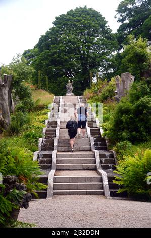 A Couple Walking up Steps to Neptune's Statue & Water Cascade at Holker Hall & Gardens, Lake District, Cumbria, England, UK. Stock Photo