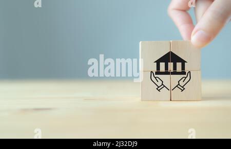 Good governance policy concept. Business moral principles concept. Businessman holds the wooden cubes with symbols hand holding the governance on beau Stock Photo