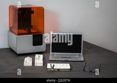 A 3D printer laptop mass model on an office table Stock Photo
