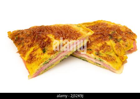 Omelette with herbs stuffed with ham and cheese isolated on white Stock Photo