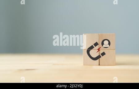 Lead generation, customer retention concept. Inbound marketing strategy. The wooden cubes with magnet attracts customer icons on beautiful grey backgr Stock Photo