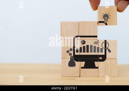 Data driven marketing concept.  Analysis market strategy,personalized and contextual marketing. Marketing technology.  Man puts the wooden cubes with Stock Photo