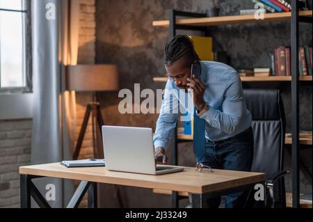 Concentrated businessman working on his notebook computer Stock Photo