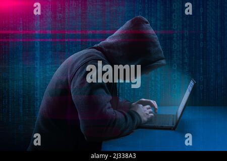 Hacker attack. Dangerous Hooded Hacker Breaks into Government Data Servers. Cybersecurity, computer hacker with hoodie. Hacking and malware concept. Stock Photo