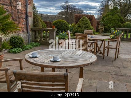 Cups and saucers on garden tables on the patio of Goldsborough Hall, Knaresborough, North Yorkshire. Stock Photo