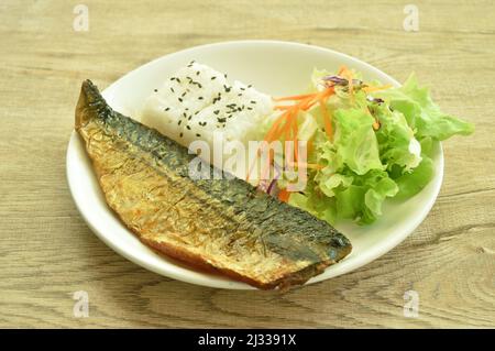 grilled saba fish or mackerel with rice topping sesame and salad on plate Stock Photo