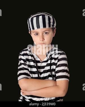 Sad prisoner wearing a striped uniform isolated on a black background Stock Photo