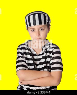 Sad prisoner wearing a striped uniform isolated on a yellow background Stock Photo