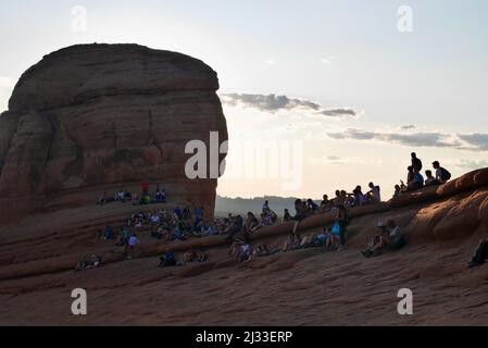 People watching the sunset at Delicate Arch. Arches National Park, Moab, Utah, USA. High quality photo Stock Photo