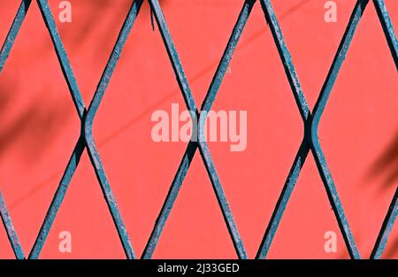 Blue mesh detail, rhombus grid on red background Stock Photo