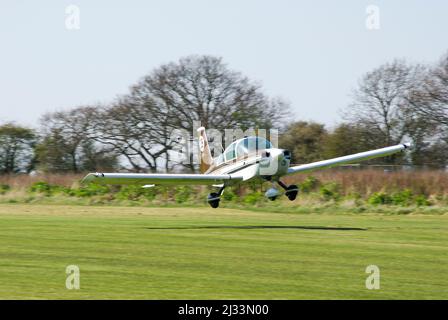 Gulfstream American AA-5B Tiger G-BOZO taking off to race at a round of the Royal Aero Club Air Race at Great Oakley airfield in rural Essex, UK Stock Photo